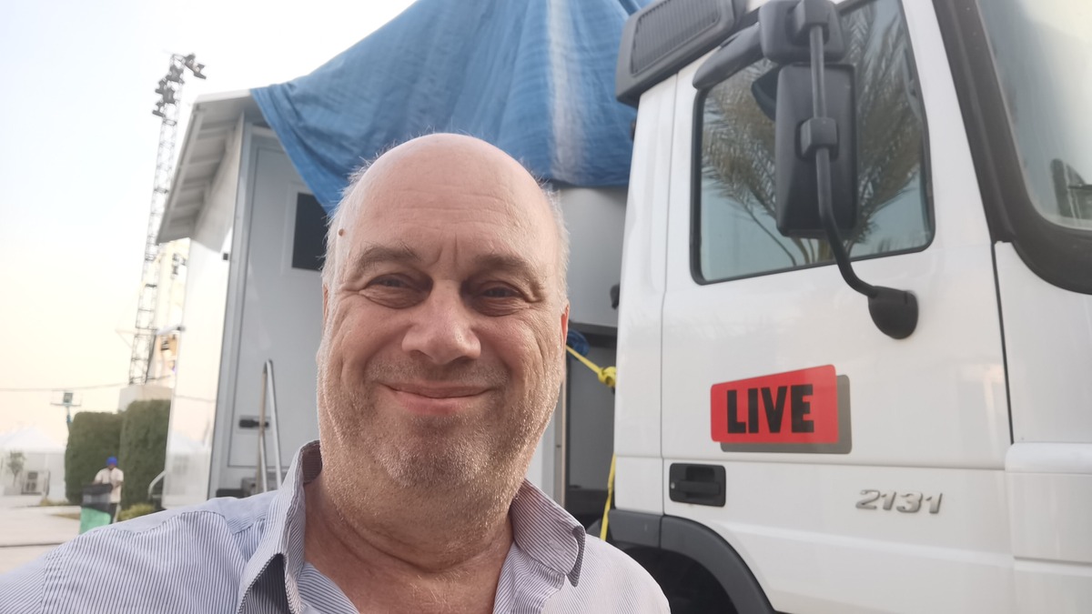 Melchior Busschers beside a LIVE outside broadcast truck.