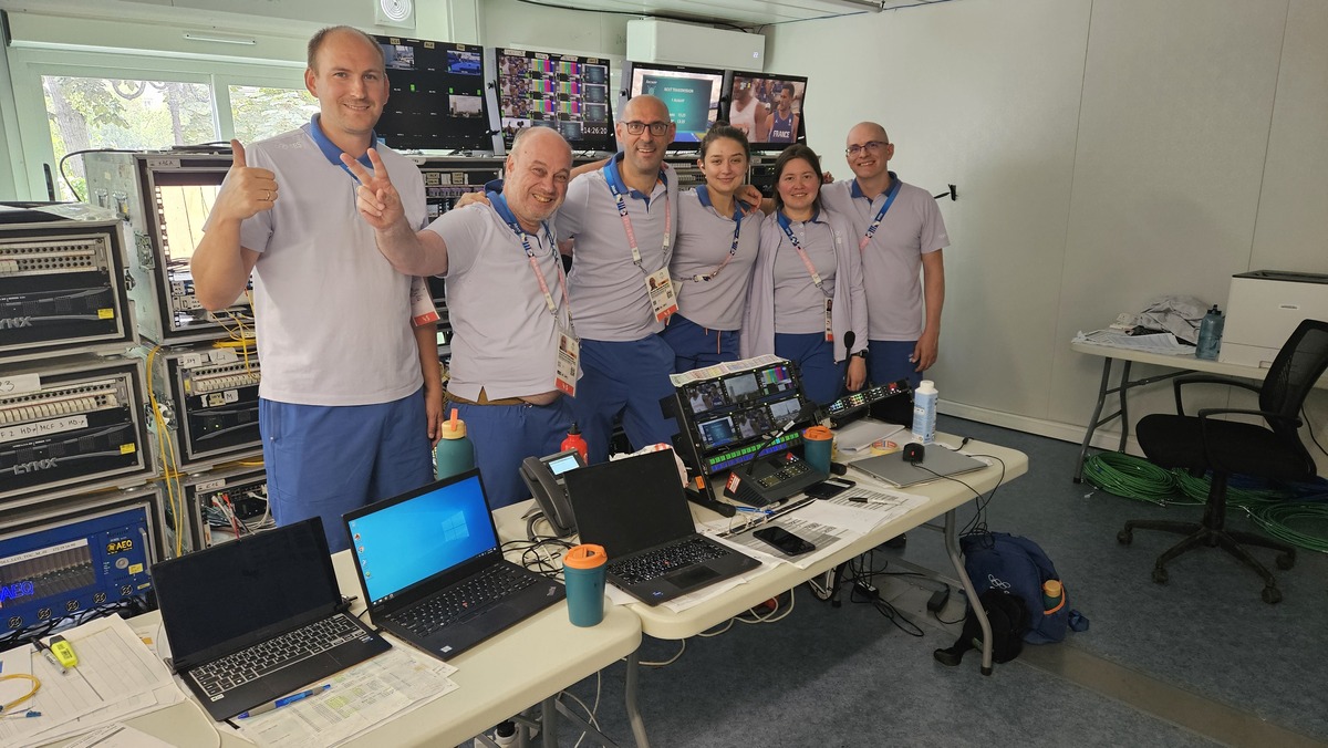 Melchior Busschers with colleagues in a production room with laptops and broadcast equipment.